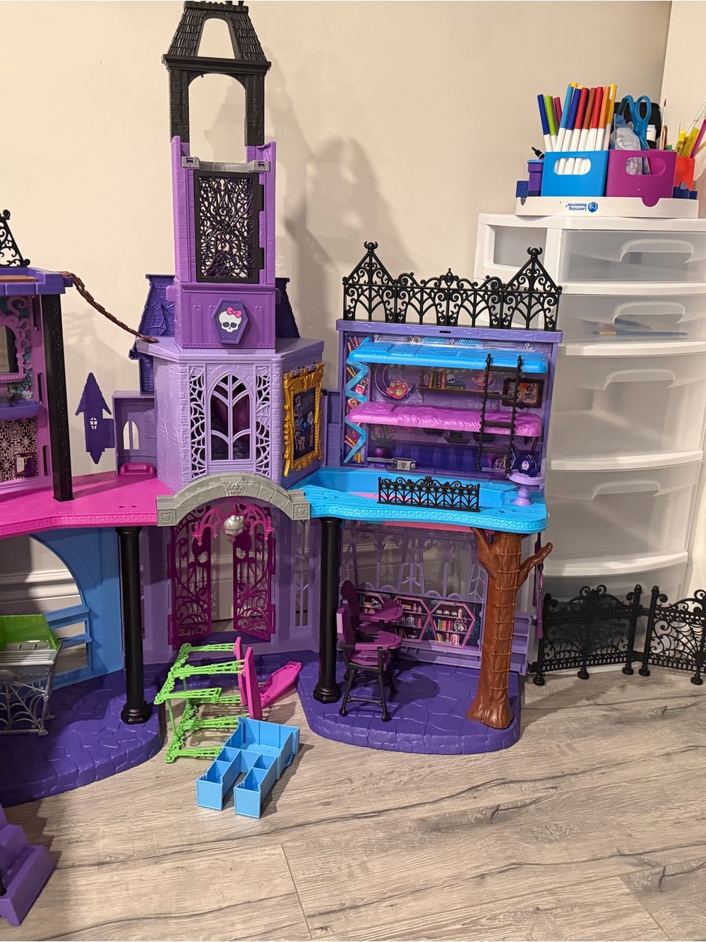 monster high purple doll house  with blue and pink accents and green ladder